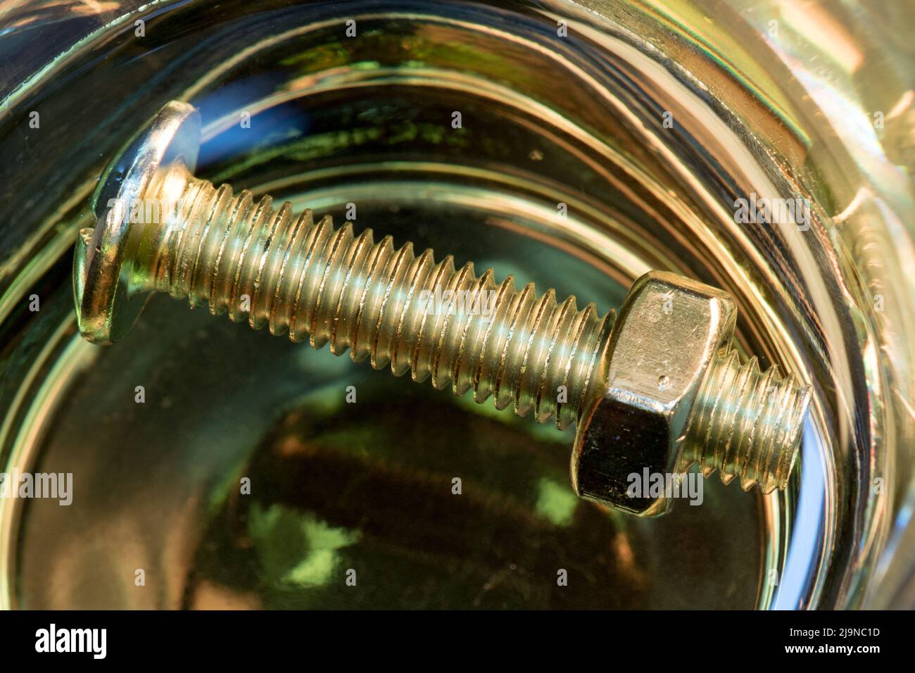Metallic nuts and bolts in lubrication oil Stock Photo Alamy