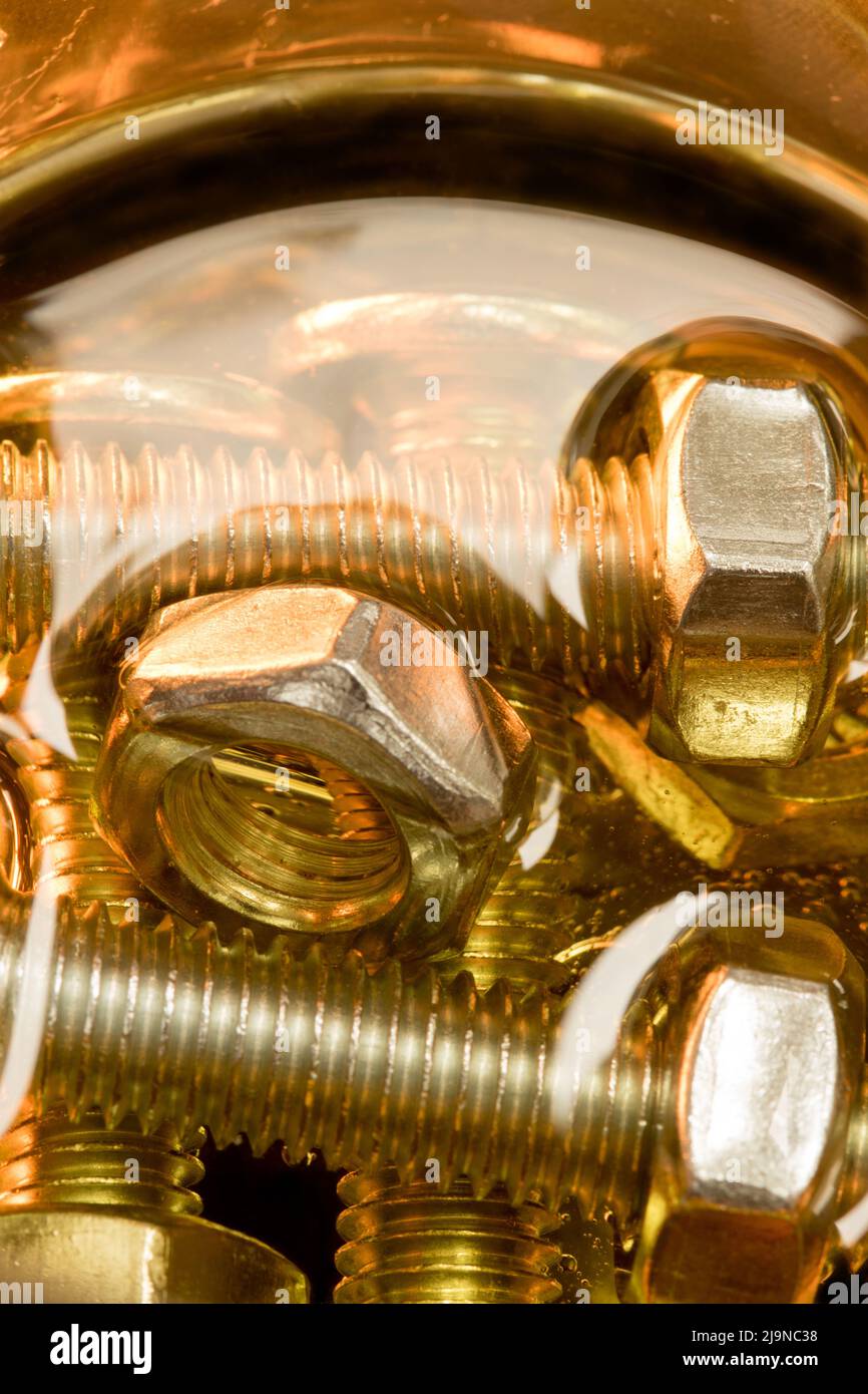 Metallic nuts and bolts in lubrication oil Stock Photo Alamy