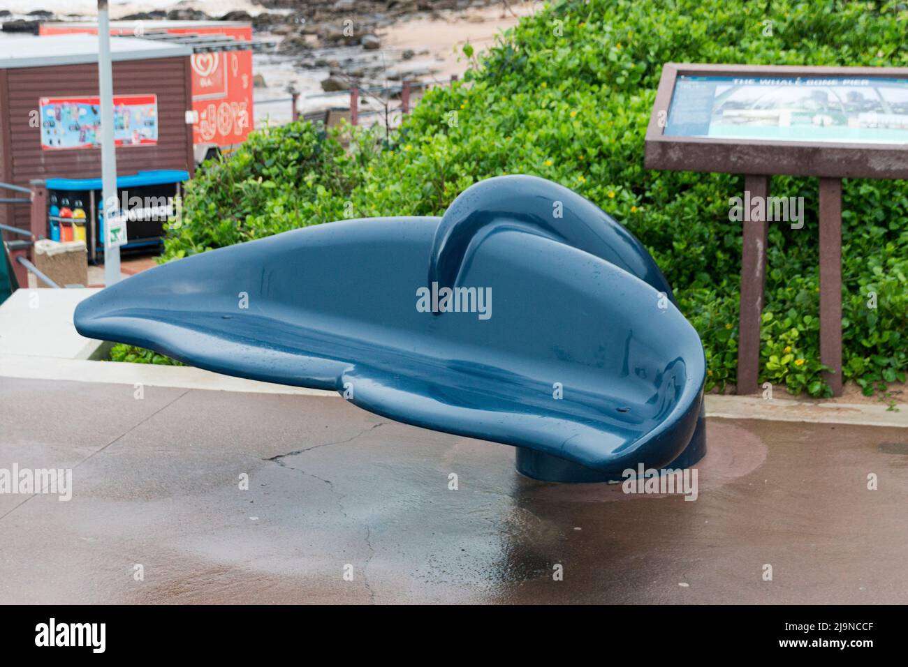 A close up view of a seat in the shape of a whales tale at the beach front Stock Photo