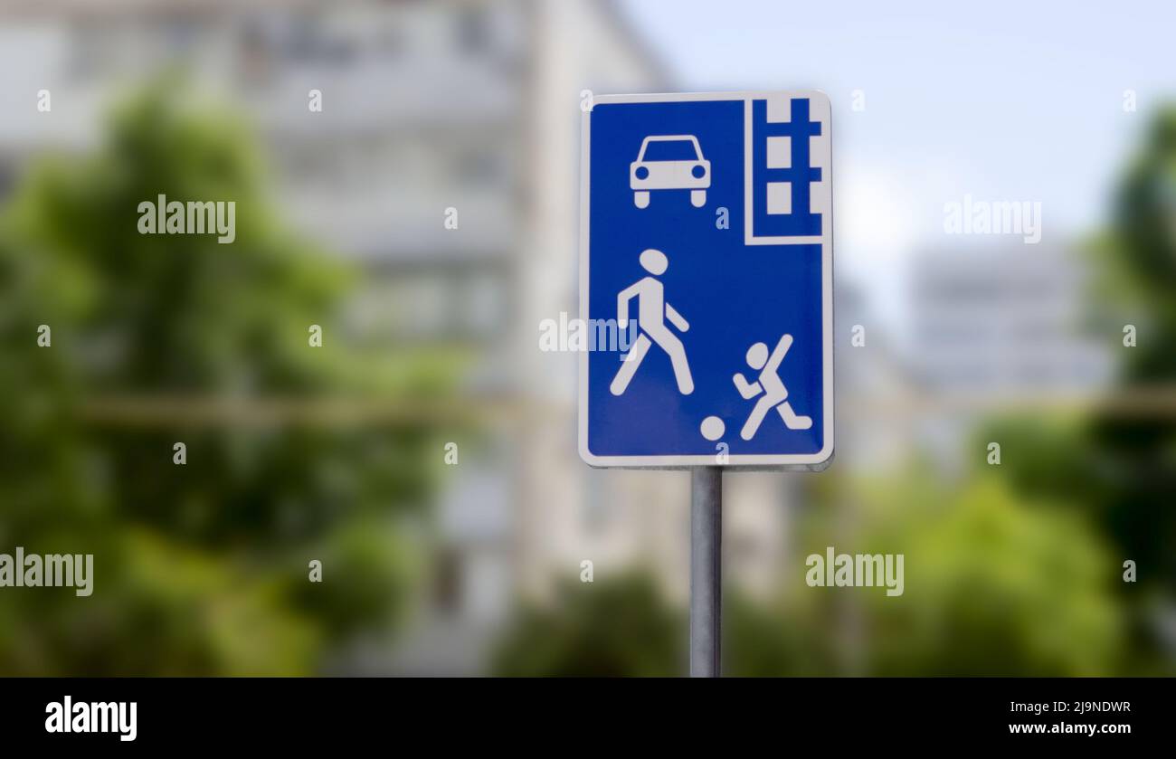 Road sign residential area on a blurred background. Square blue sign residential area on the background of houses Stock Photo