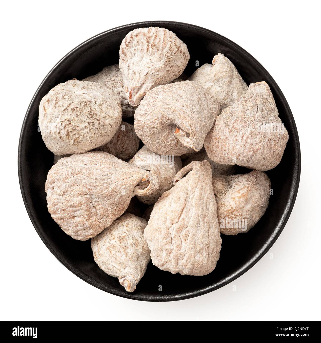 Dusted dried baby figs in a black ceramic bowl isolated on white. Top
