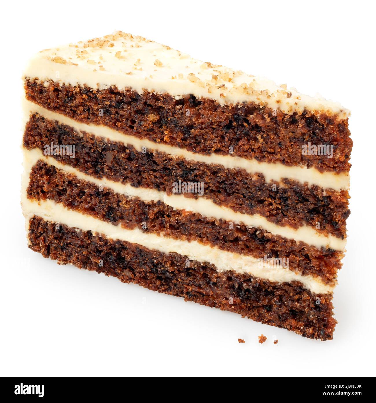 Slice of carrot cake with cream cheese filling and frosting isolated on white. Standing up. Stock Photo