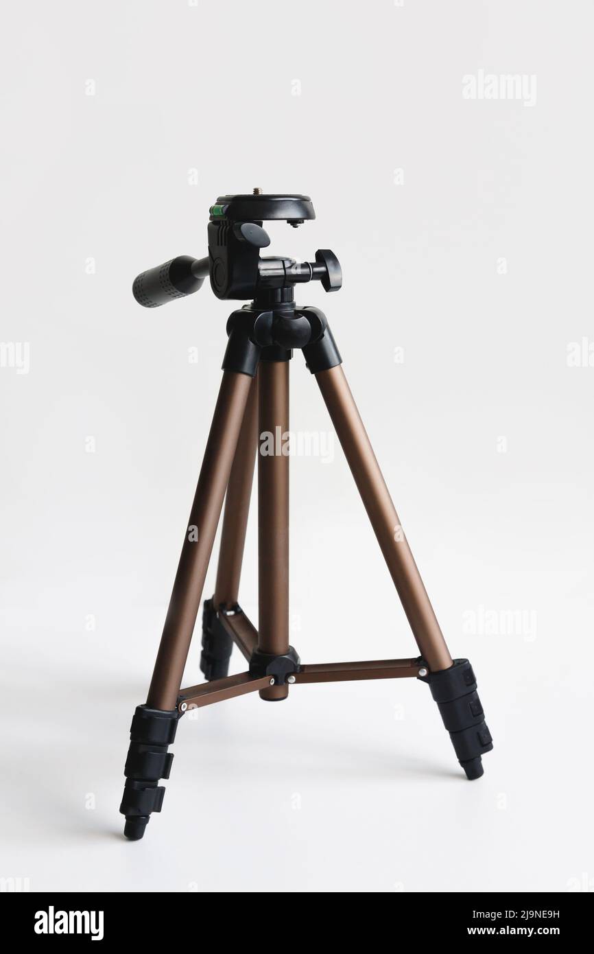 Modern compact tripod for camera on white with shadow Stock Photo - Alamy