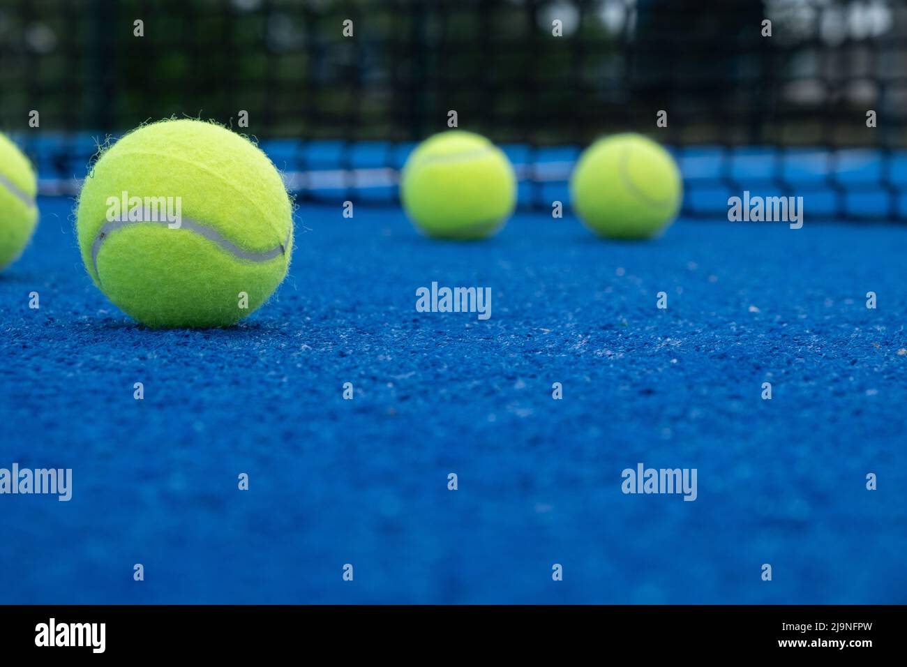 Selective focus, five balls on a paddle tennis court Stock Photo Alamy