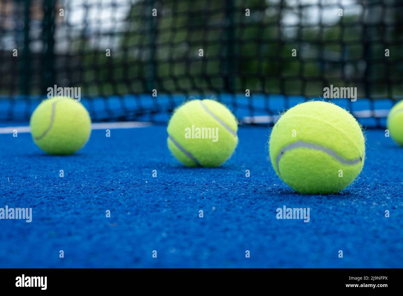 five balls on a paddle tennis court, selective focus Stock Photo Alamy