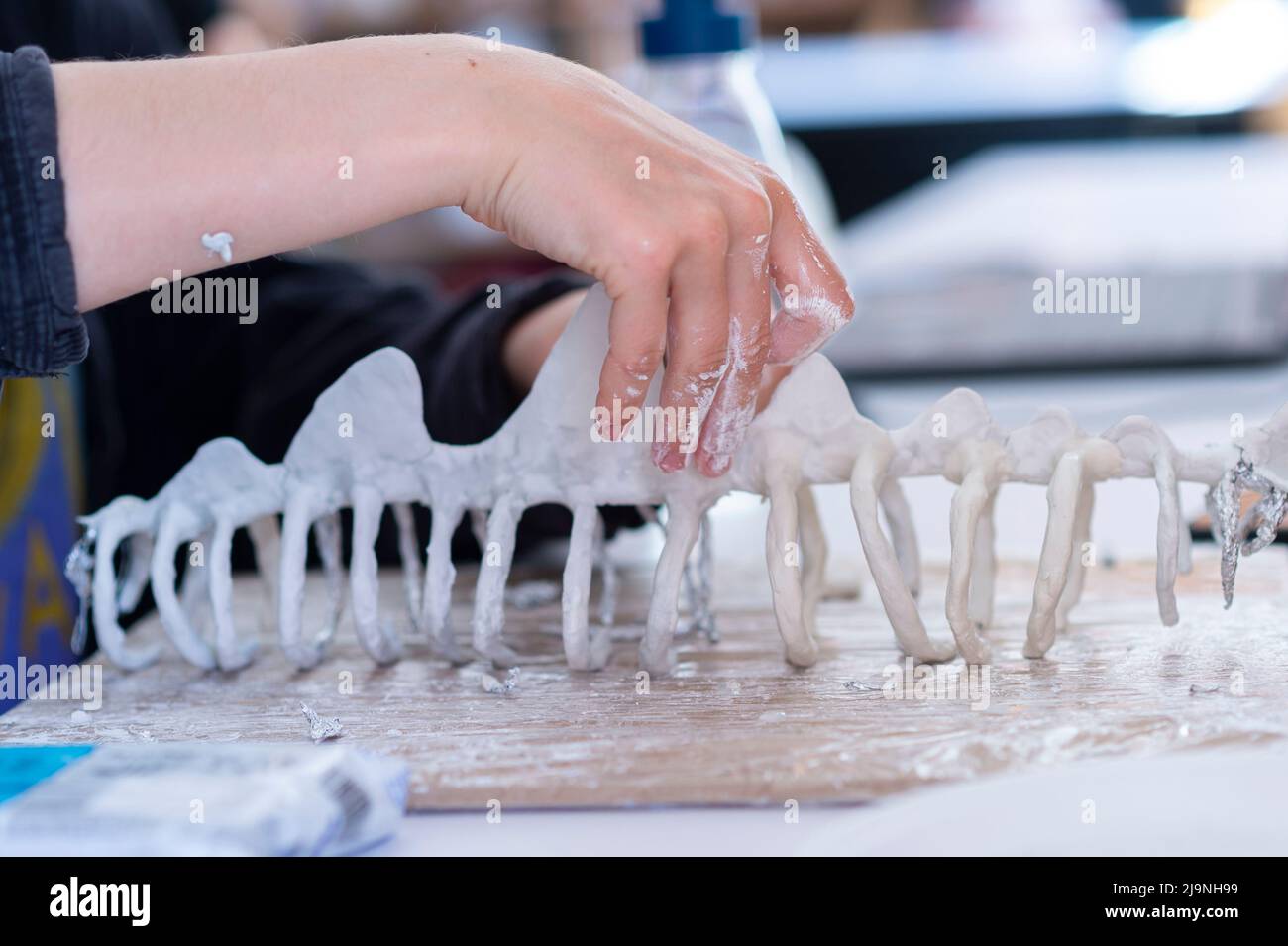 Woman molding and sculpting clay art pieces. Horizontal creative theme