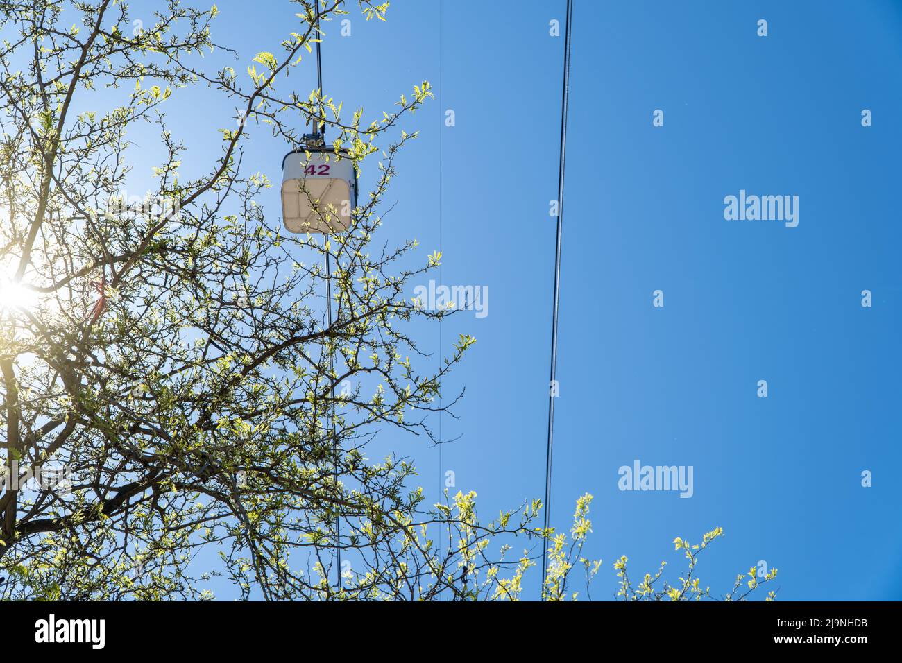 cable car cabin on blue sky background seen from below Stock Photo - Alamy
