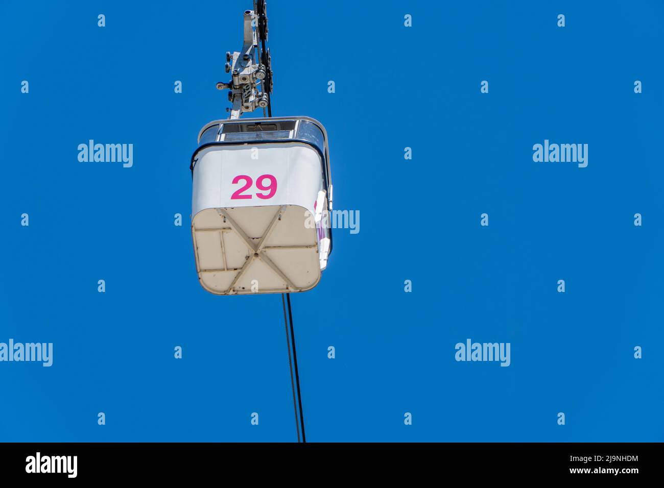 cable car cabin on blue sky background seen from below Stock Photo - Alamy