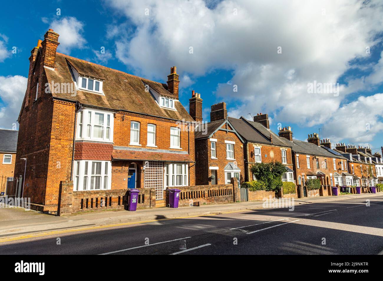 Red brick family homes along Fishponds Road in Hitchin, Hertfordshire, UK Stock Photo
