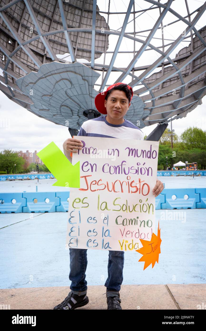 A Guatemalan Christian evangelist promotes Christianity in Flushing Meadows Corona Park which attracts a large percentage of Spanish speaking visitors. Stock Photo