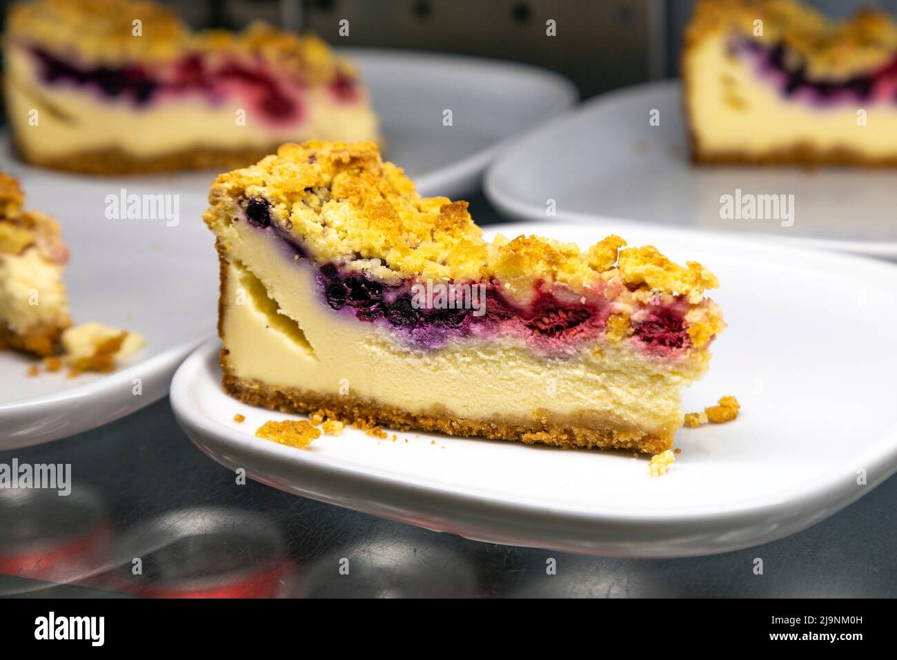 Raspberry and blueberry cheesecake slices at Ikea Stock Photo