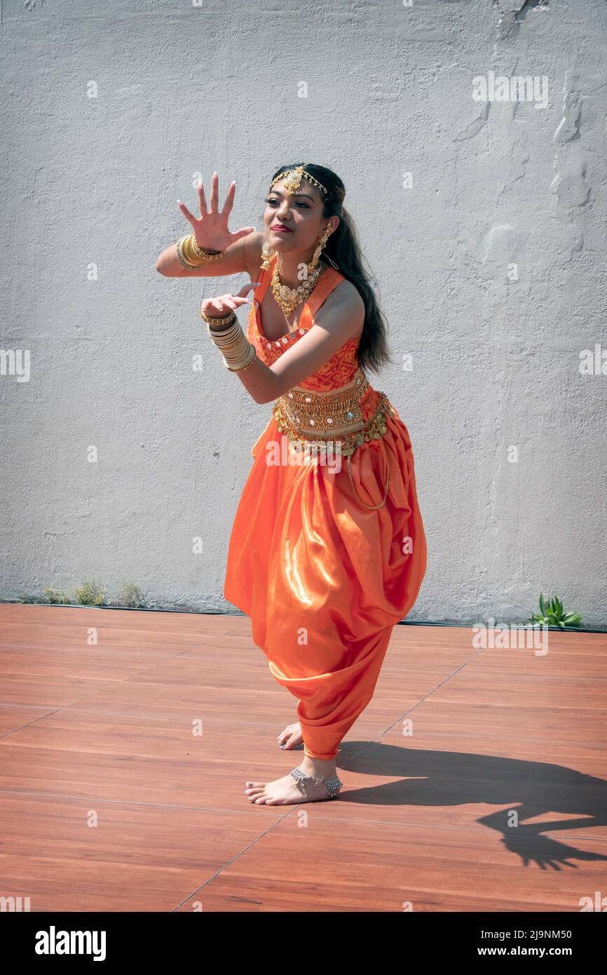 An attractive teenage dancer from the Avantikas group performs at tte Bollywood & Indian Folk Fusion Dance Concert in Charles Drew Park in Queens, NYC Stock Photo