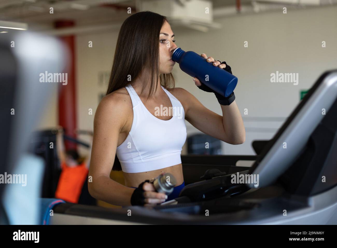 Woman drinking water after training hi-res stock photography and images ...