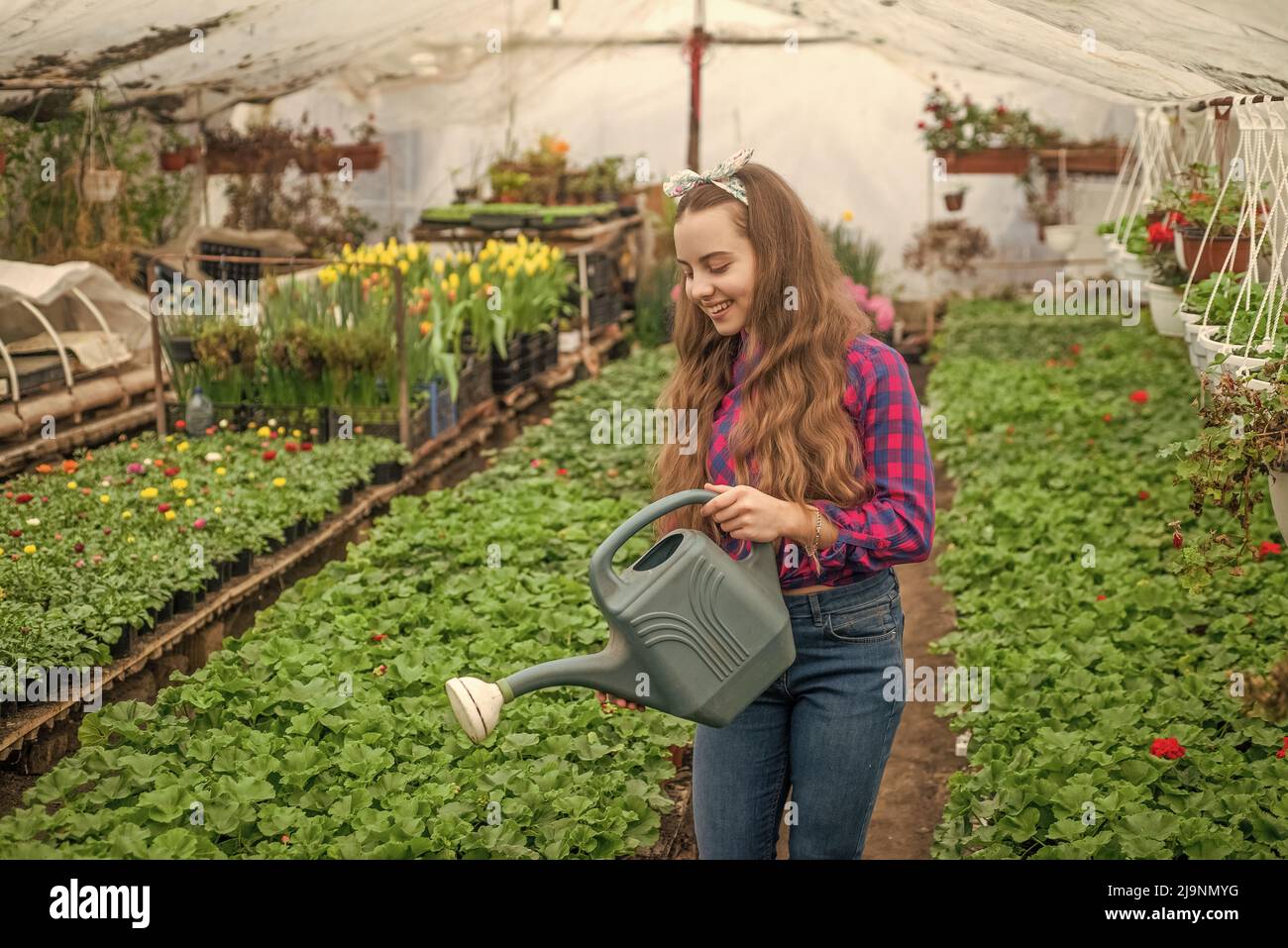 Teen girl watering garden hi-res stock photography and images - Alamy