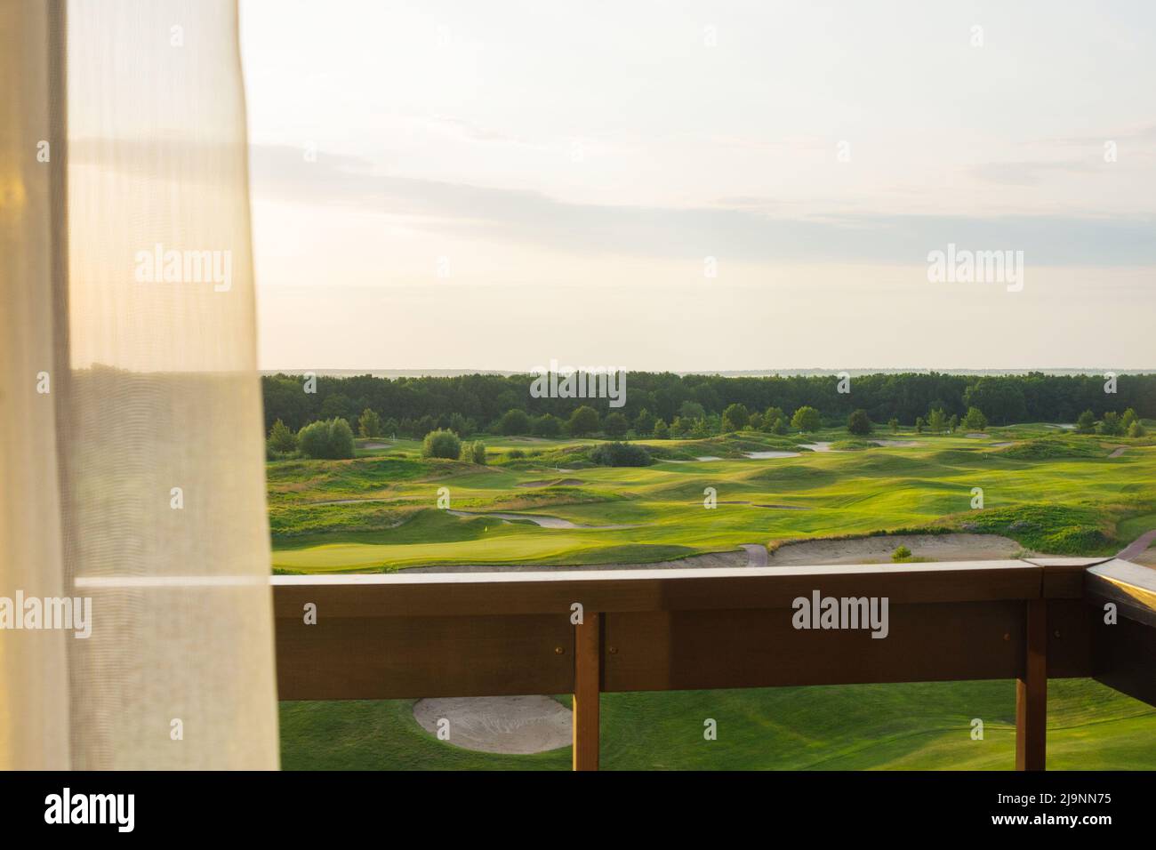 View from the balcony to the green beautiful golf course. Beautiful