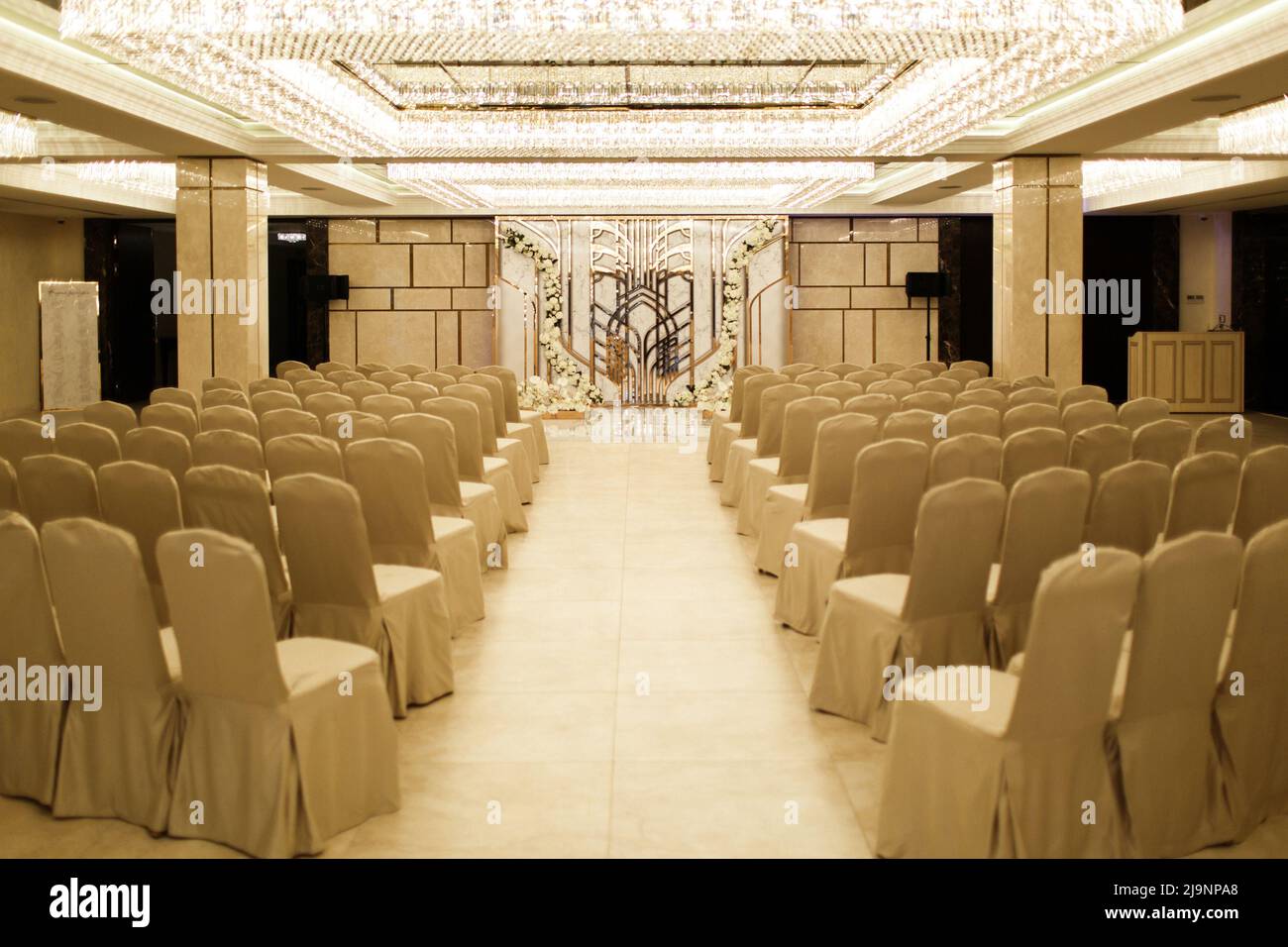Outdoor wedding ceremony in the hotel. Flowers and glowing ceiling ...