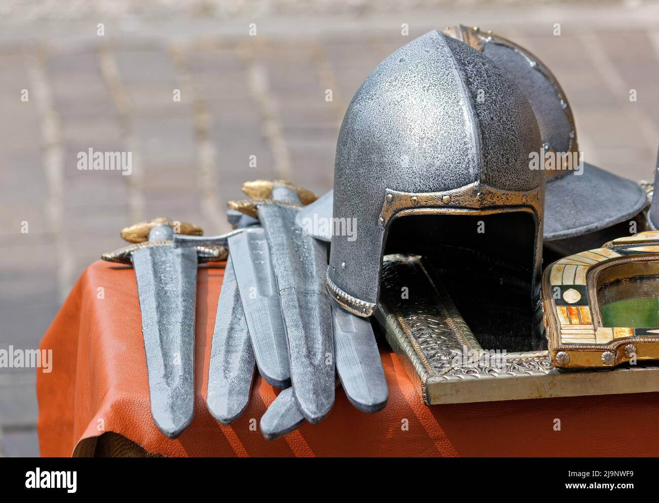 Daggers, helmets and other objects on display during an ancient history historical reenactment Stock Photo