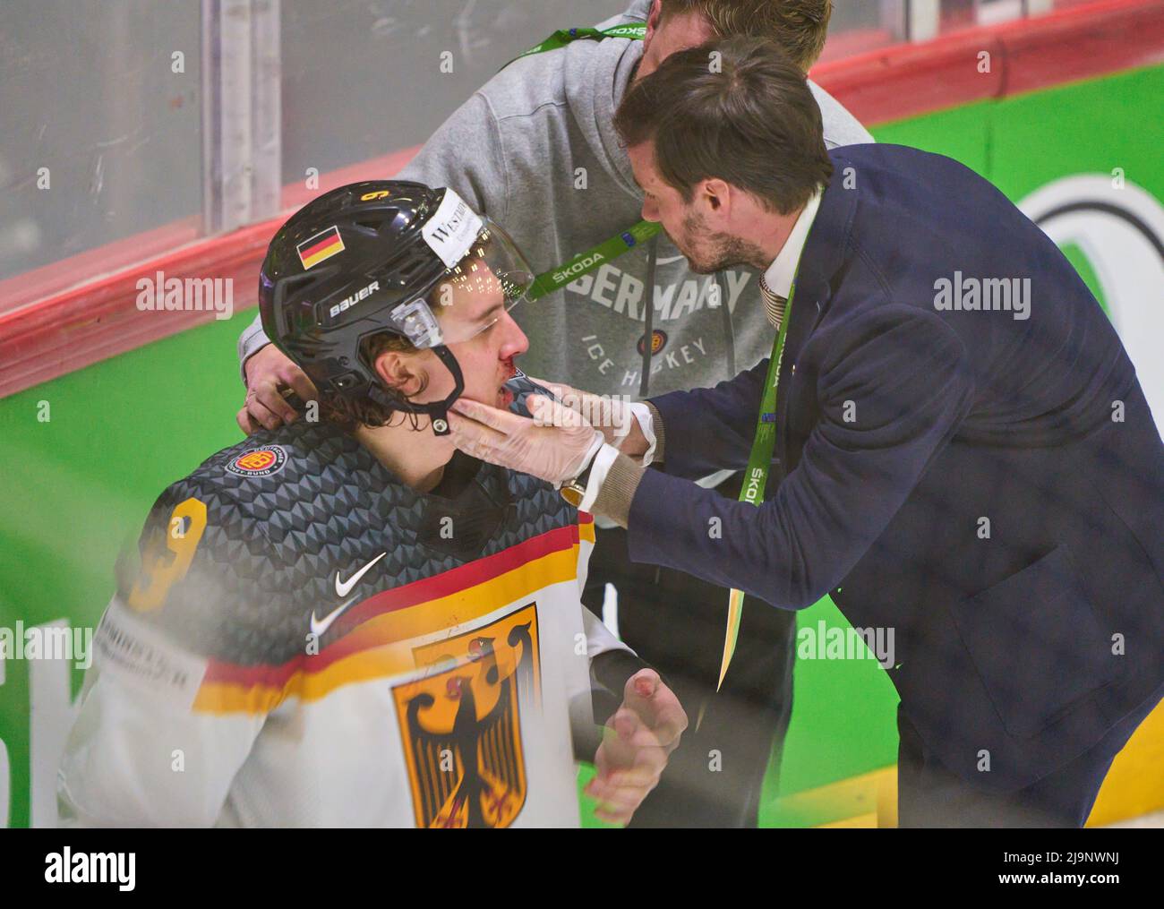 Helsinki, Finland. 24th May, 2022. Leon Gawanke Nr.9 of Germany injured after foul of Denis Malgin, SUI 62 , Dr. Fabian BLANKE, DEB Mannschaftsarzt, team doctor, Facharzt für Orthopädie und Unfallchirurgie treat him in the match GERMANY - SWITZERLAND 3-4 after penalty shootout IIHF ICE HOCKEY WORLD CHAMPIONSHIP Group A  in Helsinki, Finland, May 24, 2022,  Season 2021/2022 © Peter Schatz / Alamy Live News Stock Photo