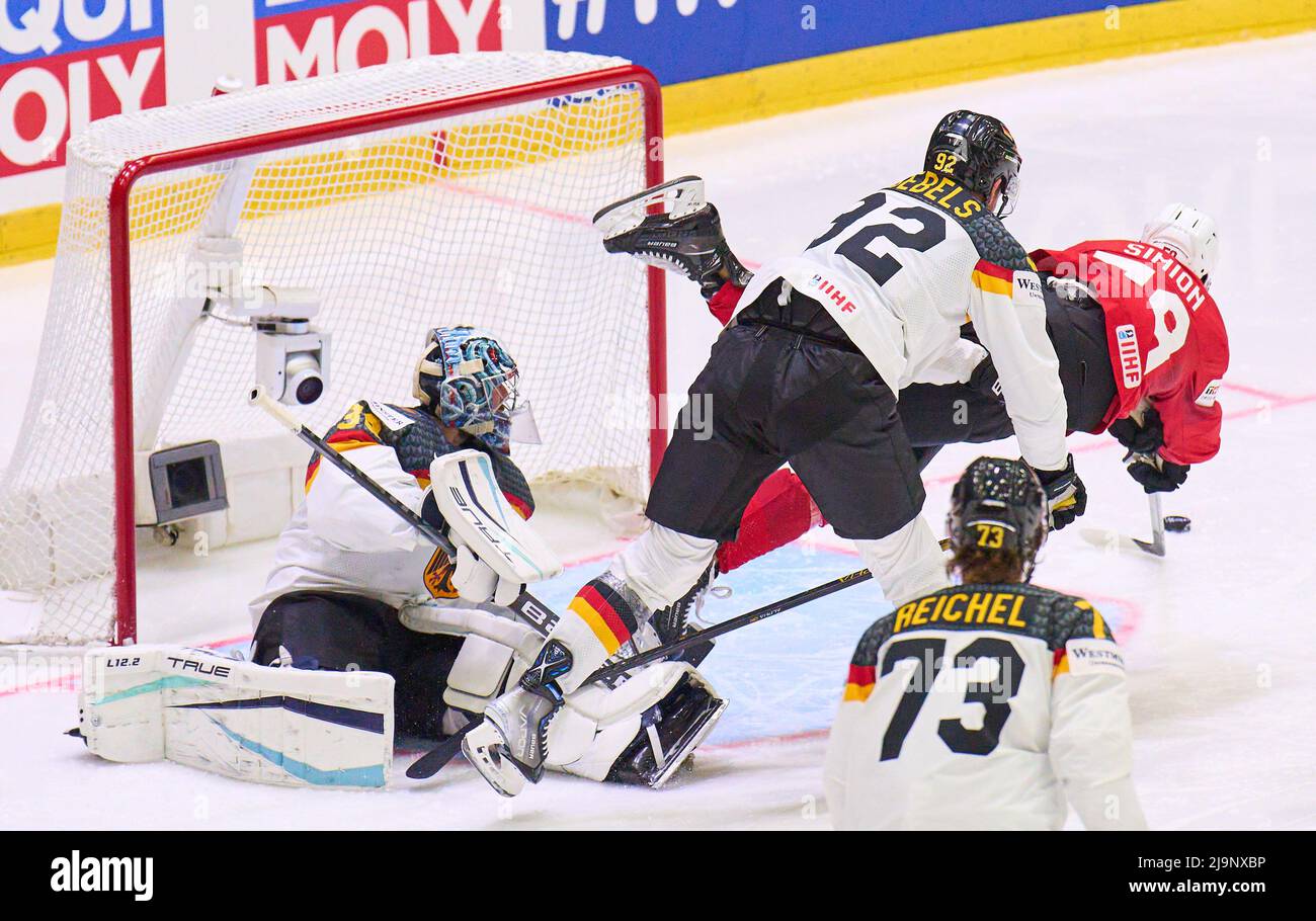 Helsinki, Finland. 24th May, 2022. Dario Simion Nr. 59 of Switzerland compete, fight for the puck against, Philipp GRUBAUER Goalie  Nr.30 of Germany Marcel Noebels Nr. 92 of Germany  in the match GERMANY - SWITZERLAND 3-4 after penalty shootout IIHF ICE HOCKEY WORLD CHAMPIONSHIP Group A  in Helsinki, Finland, May 24, 2022,  Season 2021/2022 © Peter Schatz / Alamy Live News Stock Photo