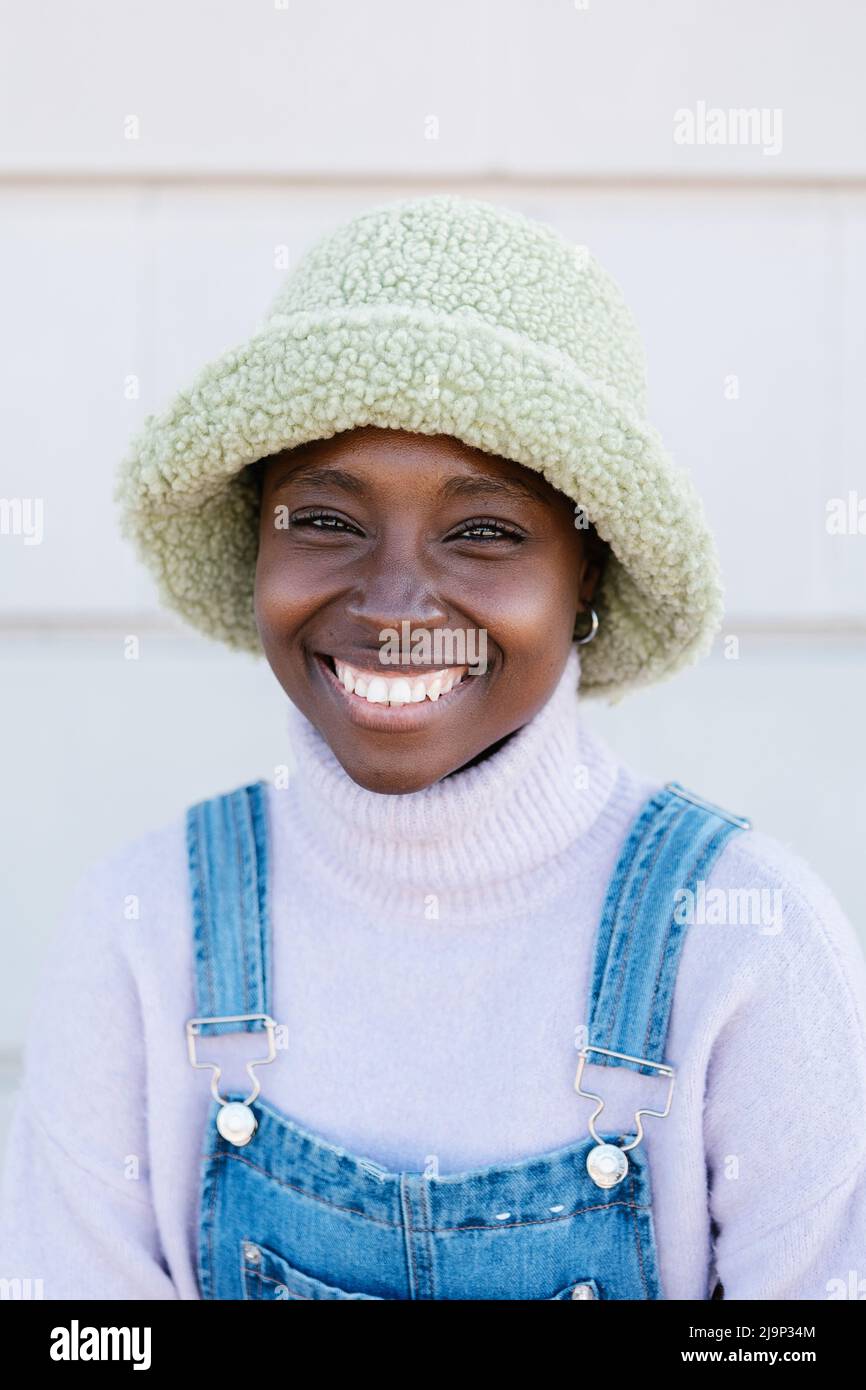 Vertical portrait of trendy young african woman smiling at camera ...