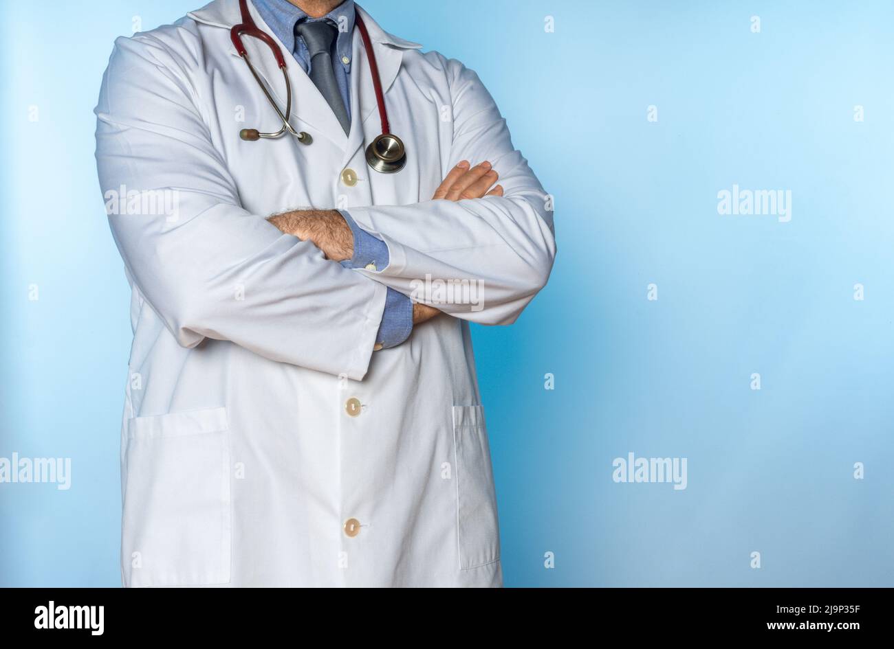 doctor in white coat and stethoscope with crossed arms Stock Photo - Alamy