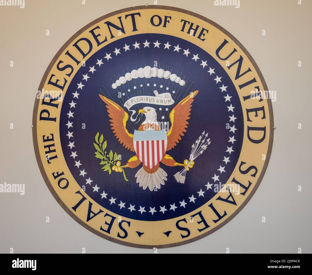 Simi Valley, California, USA - April 27, 2022: Ronald Reagan Presidential Library. Closeup of Presidential seal against beige wall. Stock Photo