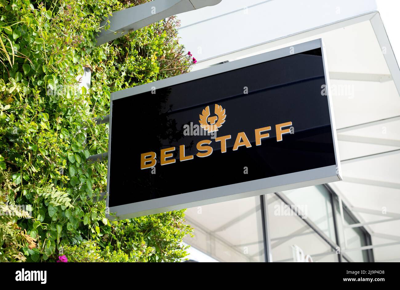 Close up of Belstaff luxury retail fashion shop sign at Ashford Outlet  Center, Kent, England, UK Stock Photo - Alamy