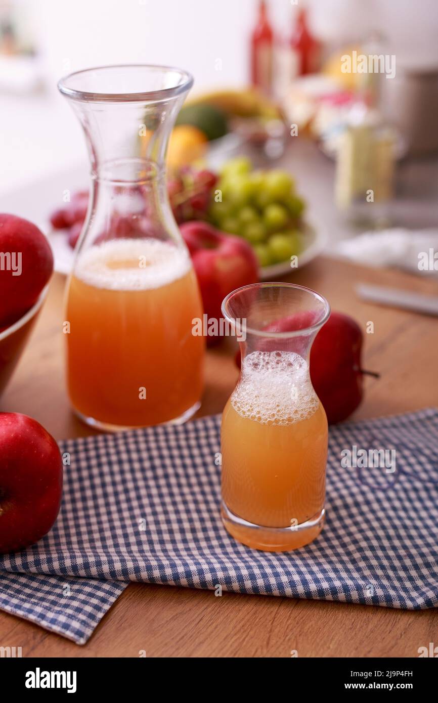 Fresh detox juice from fruit in glass bottles on kitchen counter Stock Photo