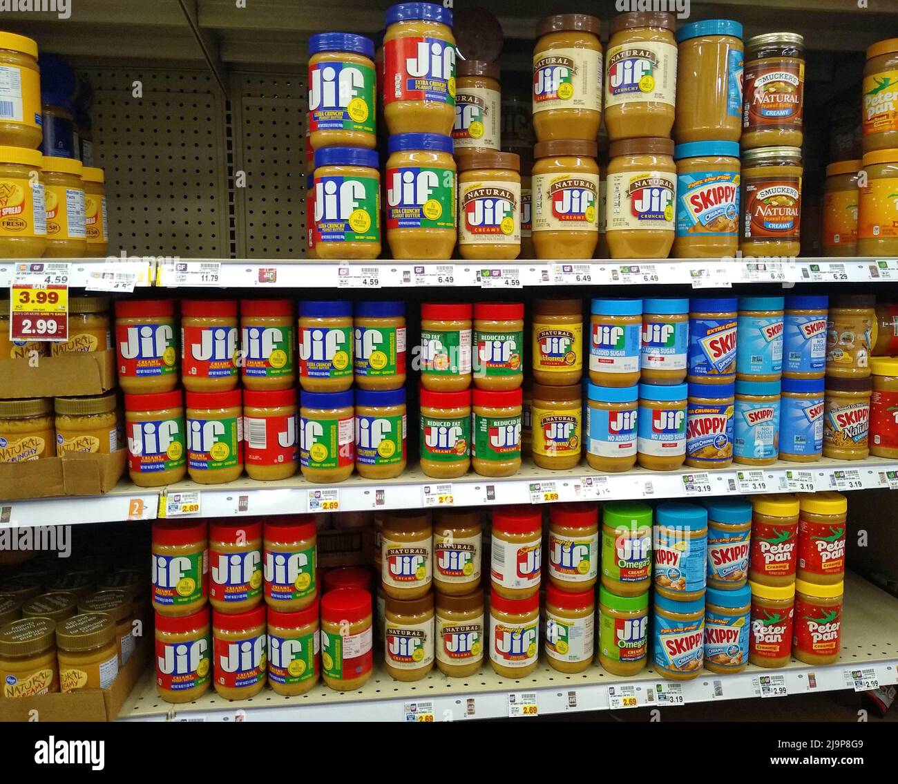 Jar of Jif peanut butter occupy three shelves alongside other peanut butter and peanut spread offerings from Kroger, Smucker's, Skippy and Peter Pan brands on Sunday, May 22, 2022 at Kroger #770 in Owensboro, Daviess County, KY, USA. The J.M. Smucker Co. issued a voluntary recall for select Jif peanut butter products due to potential Salmonella contamination on May 20, 2022, and a Kroger assistant manager removed all Jif peanut butter products from this store's shelves on May 24, 2022. (Apex MediaWire Photo by Billy Suratt) Stock Photo