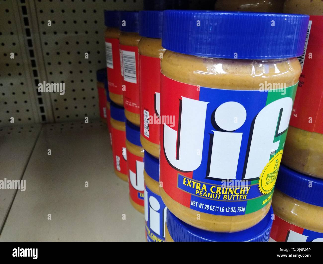 Jars of Jif Extra Crunchy peanut butter sit on a shelf on Sunday, May