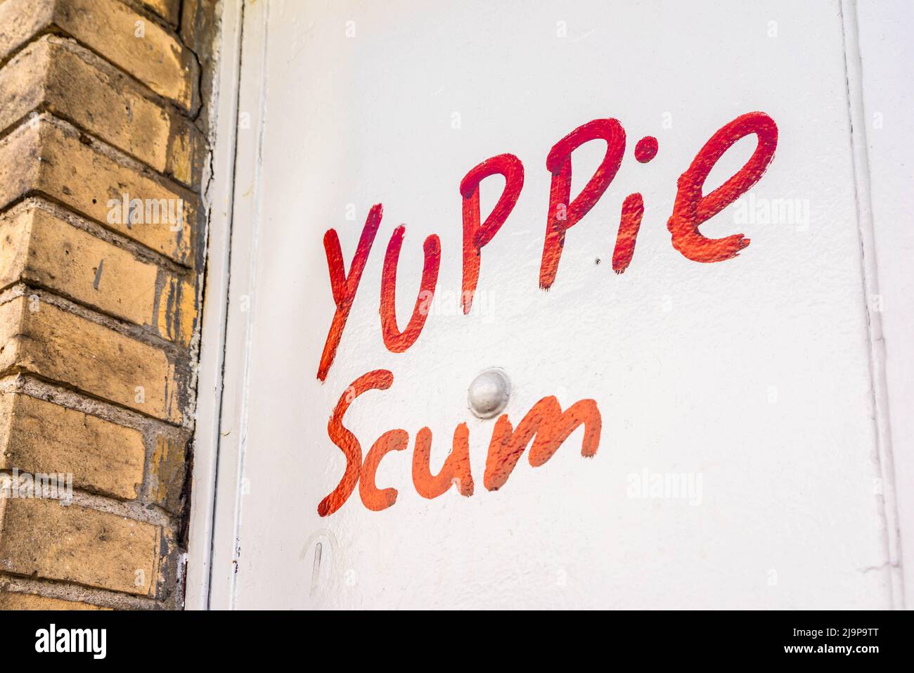 Yuppie scum graffiti in red letters on a door in Berlin, Germany, Europe Stock Photo