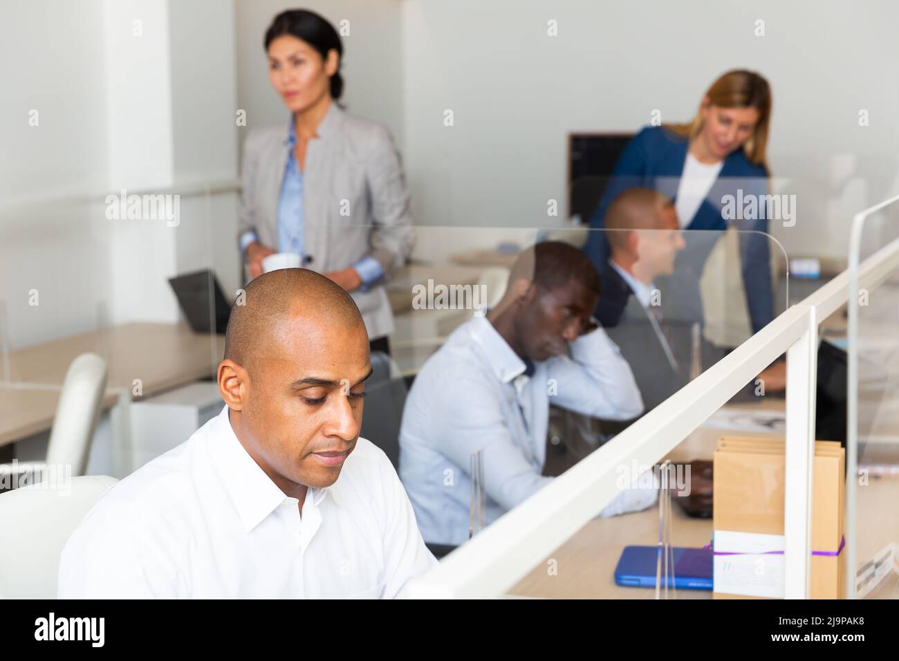 Successful manager works for laptops in office Stock Photo