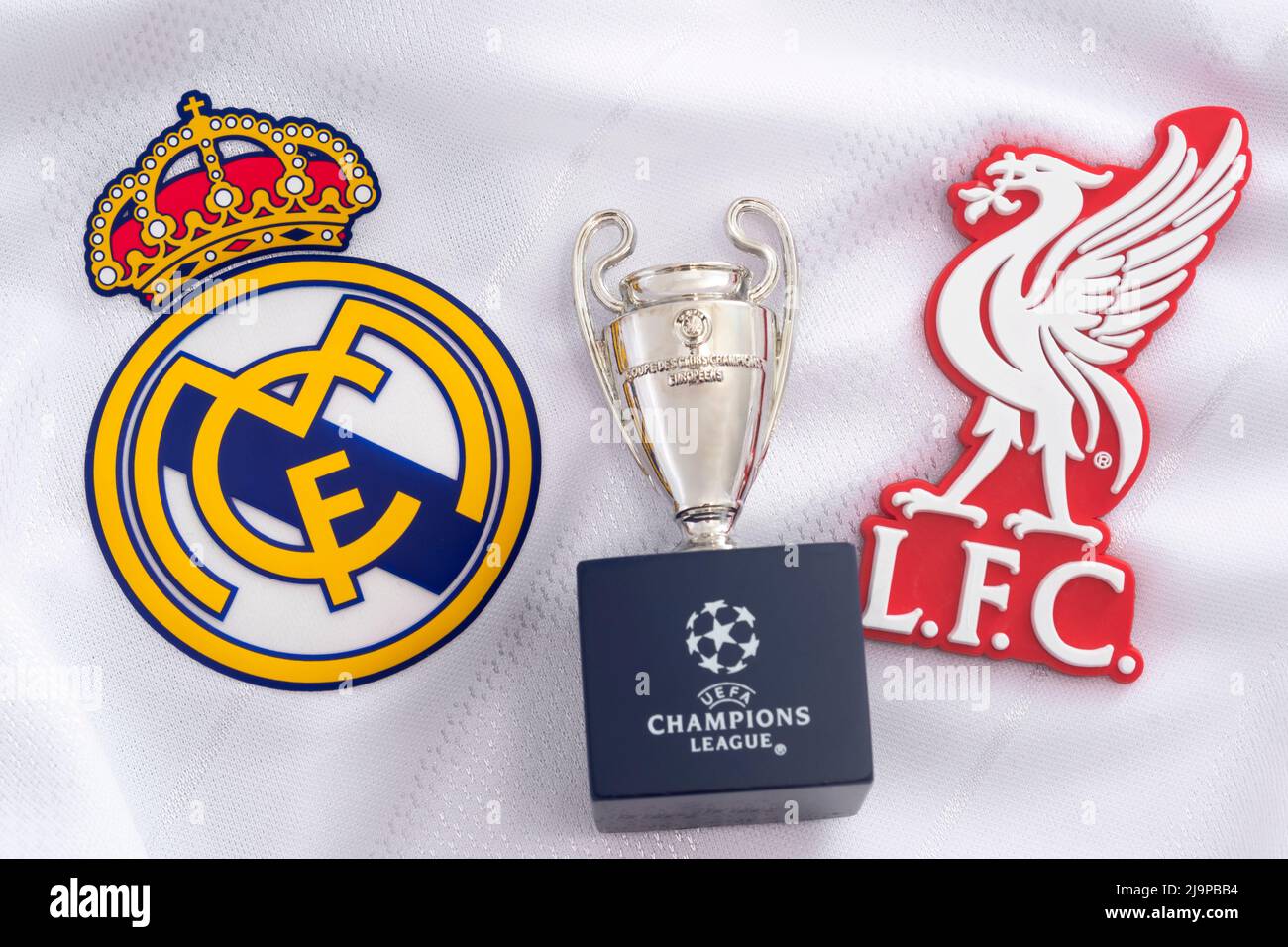 Croydon, UK - May 24, 2020: illustrative editorial of replica of the Champions league trophy, the emblem of Real Madrid and the badge of Liverpool (th Stock Photo
