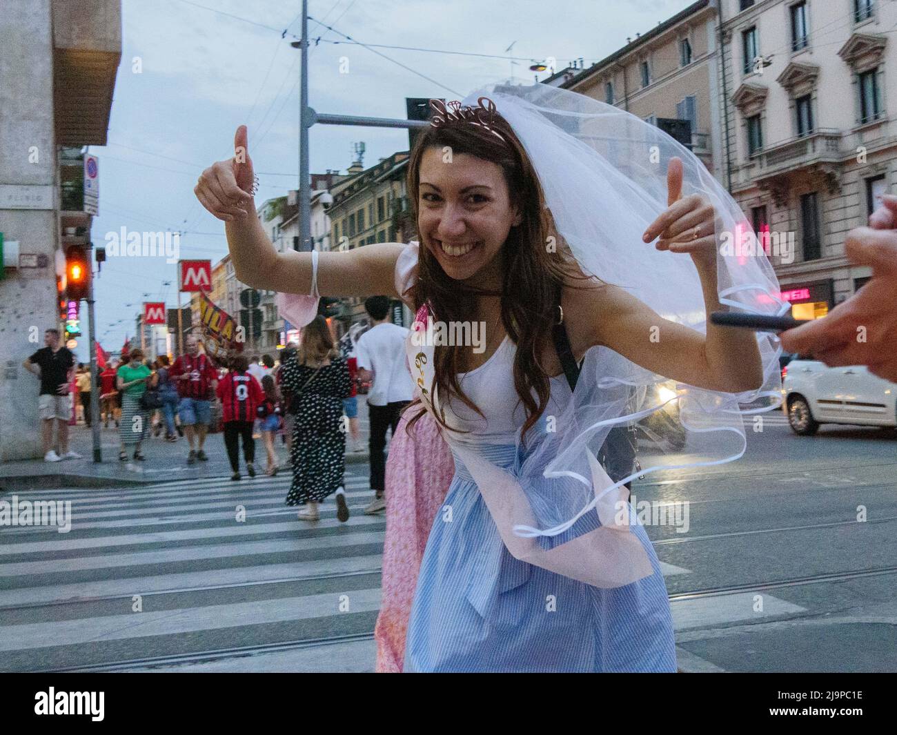 Fans of AC Milan celebrate after winning the Italian Serie A Championship on Corso Buenos Aires, on May 22, 2022 in Milan, Italy. Stock Photo