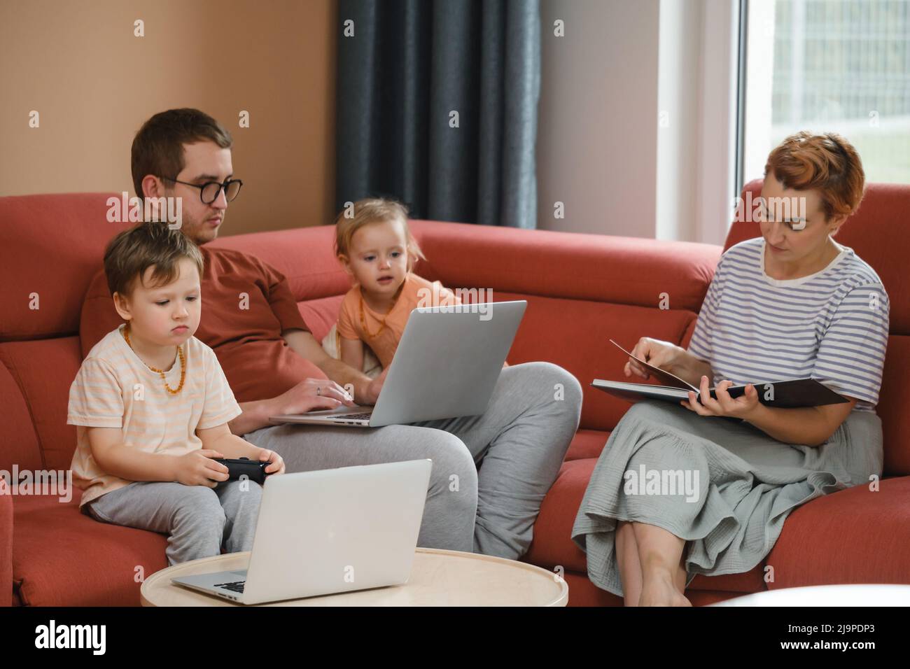 Big happy family watching movies playing games on laptop. Mother father