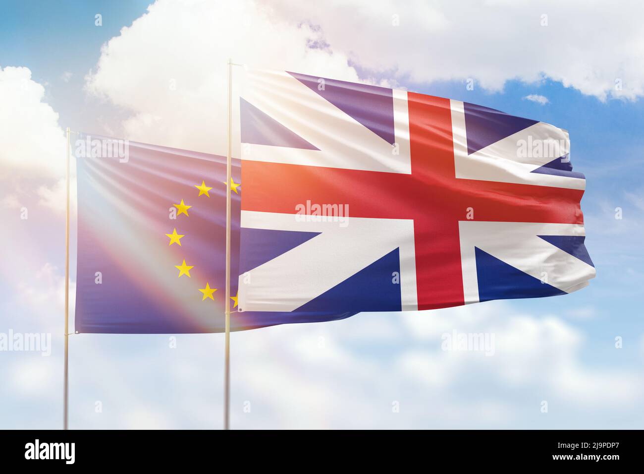 Sunny blue sky and flags of great britain and european union Stock Photo