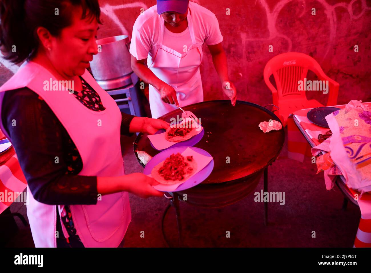 Vendors serve tacos inside of tortillas at a public market in Ozumba de Alzate, State of Mexico, Mexico, May 24, 2022. REUTERS/Edgard Garrido Stock Photo