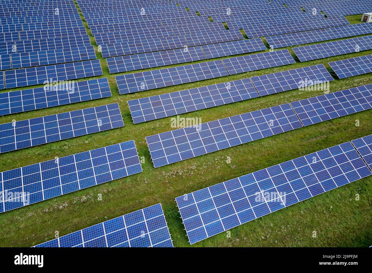 Aerial view of big sustainable electric power plant with many rows of