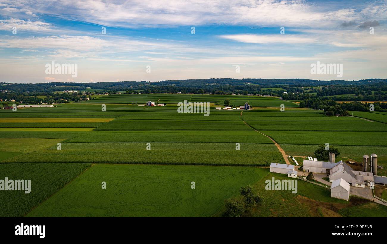 Aerial View of Farmlands With Barns and Silos, Looking Over the Hills ...