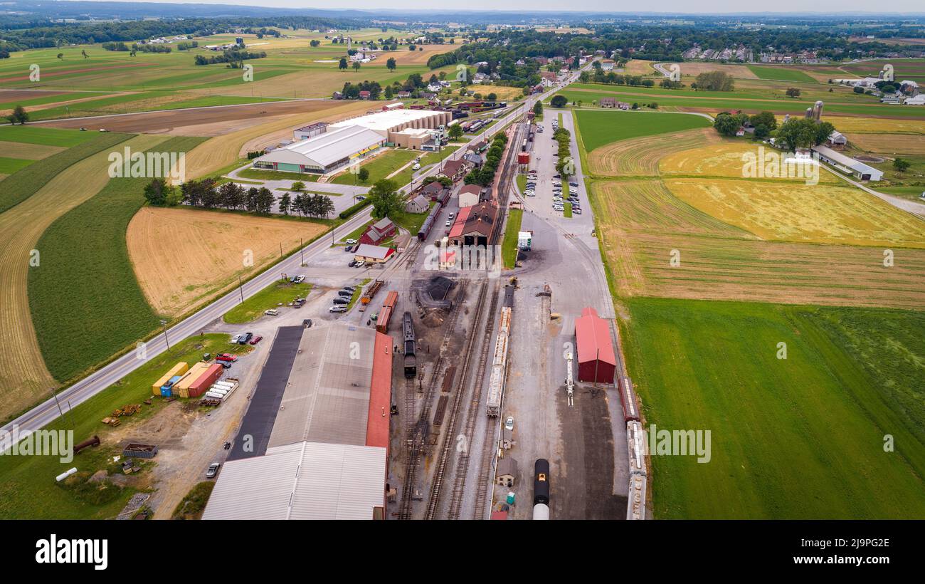 Drone View of a Steam Passenger Station And Freight Yard With Rolling Stock and Empty Tracks on a Cloudy Summer Day Stock Photo