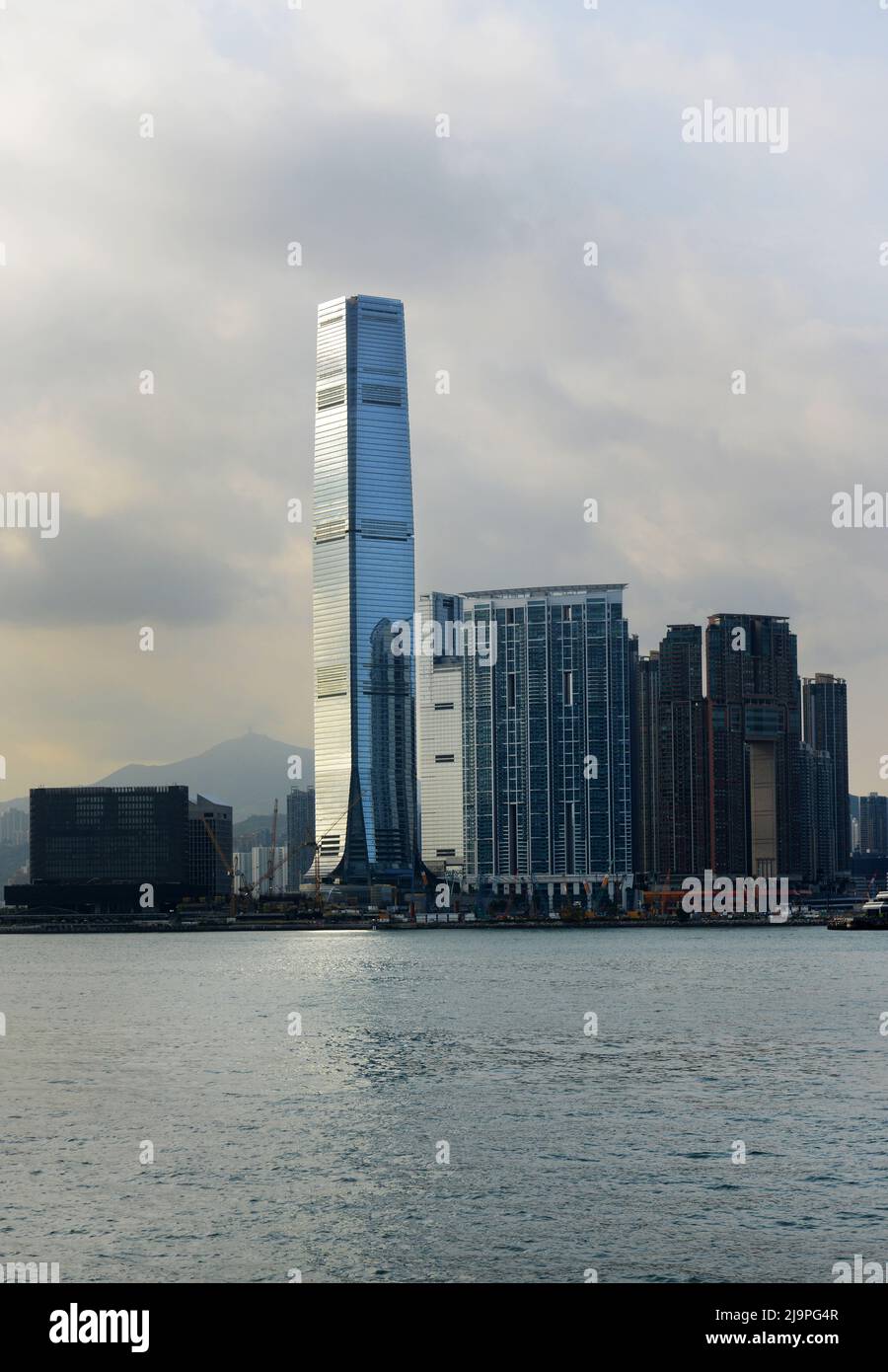 Victoria Harbour with the ICC tower and the West Kowloon cultural district in the background. Stock Photo