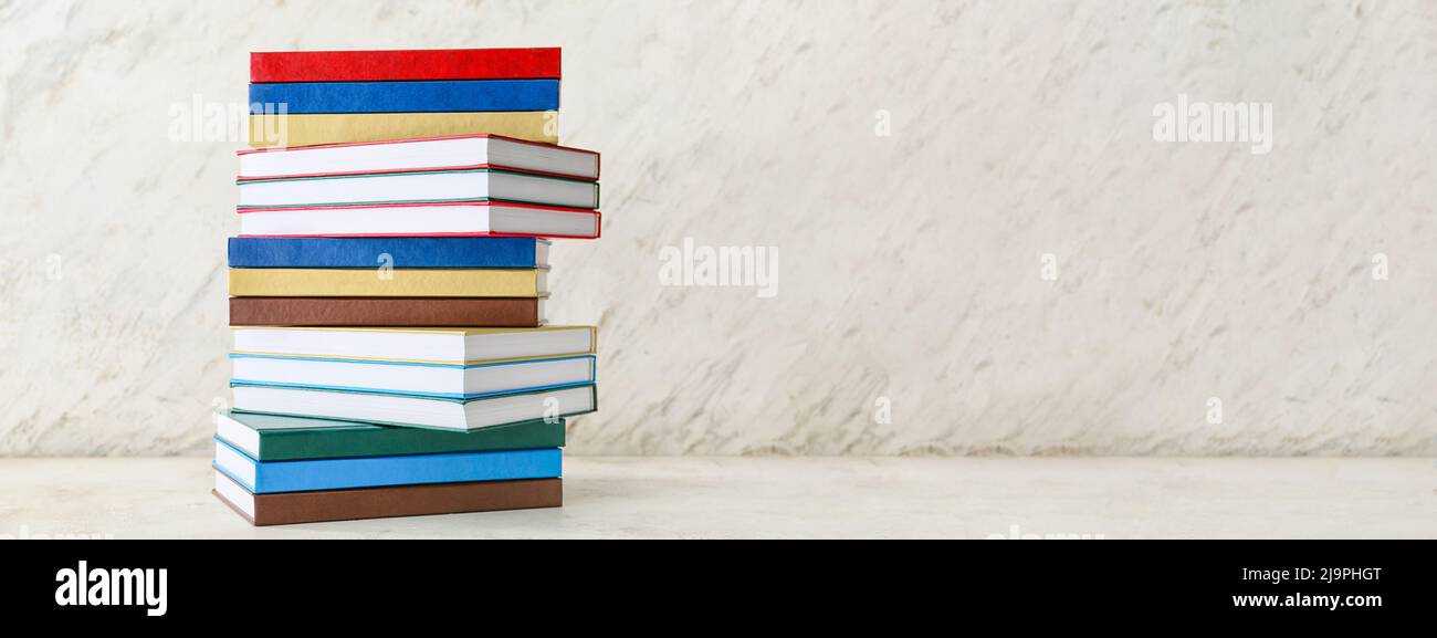 Stacks of books on light background. Banner for design Stock Photo - Alamy