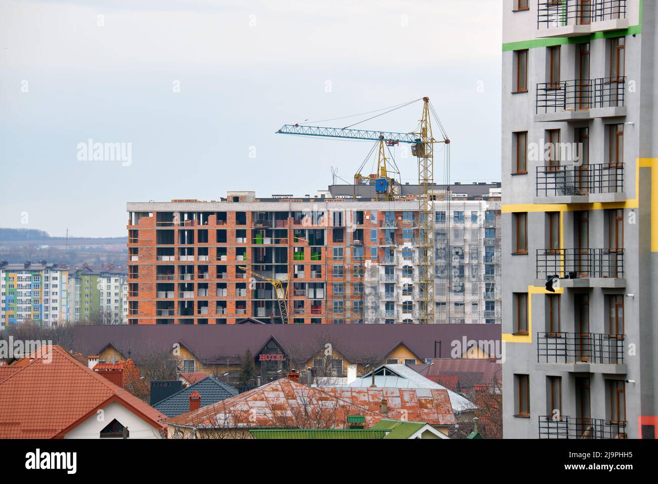 Tower cranes at high residential apartment buildings construction site