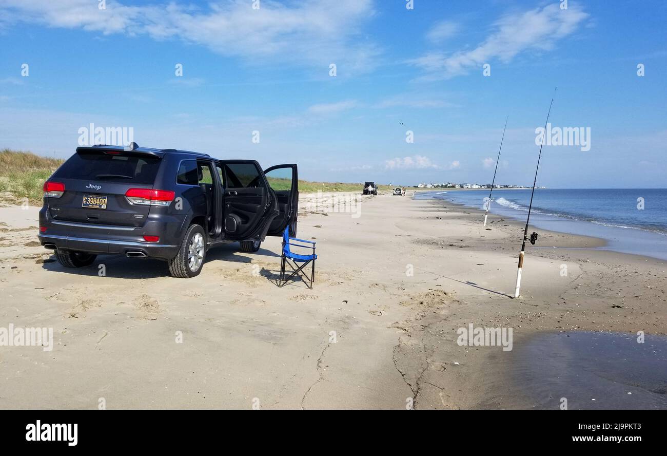 Broadkill Beach, Delaware, U.S.A - May 16, 2022 - A Jeep Cherokee parked on the beach overlooking the surfishing rods Stock Photo