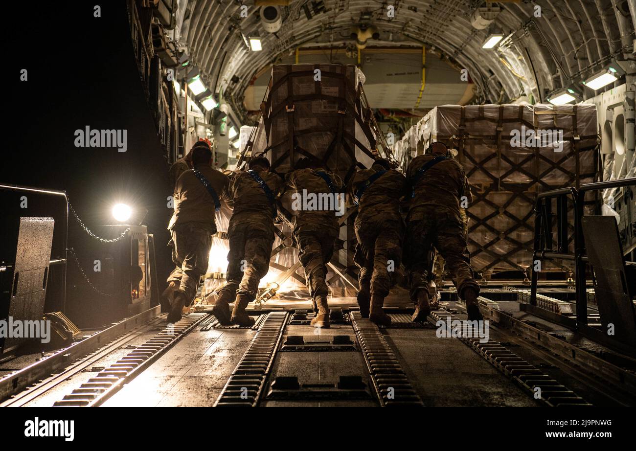 U.S. Air Force Airmen assigned to the 721st Aerial Port Squadron load a pallet of infant formula onto a C-17 Globemaster lll aircraft assigned to Joint Base Pearl Harbor-Hickam, Hawaii, at Ramstein Air Base, Germany, May 22, 2022. The President of the United States launched Operation Fly Formula to speed up the import of infant formula from Europe to the United States due to critical shortages there. (U.S. Air Force photo by Airman 1st Class Jared Lovett) Stock Photo