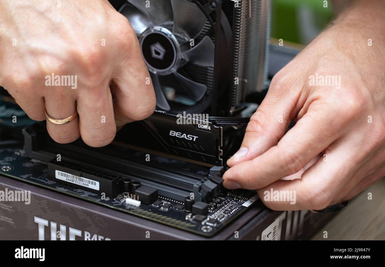 Close up of technician man installing Fury Beast RAM DDR4 stick on  motherboard of professional computer for cryptocurrency mining. Russia,  17.08.2021 Stock Photo - Alamy