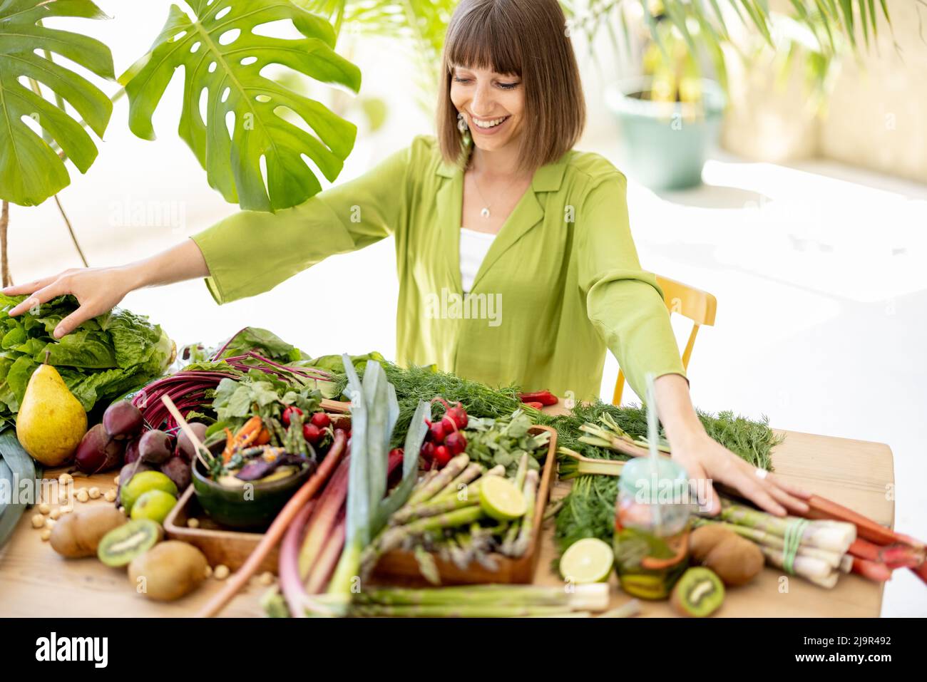 Woman with fresh healthy food ingredients indoors Stock Photo