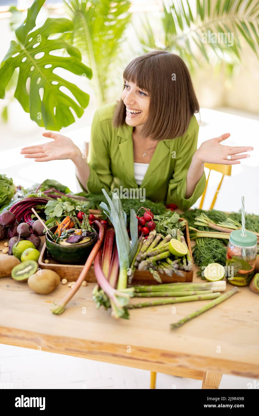 Woman with fresh healthy food ingredients indoors Stock Photo