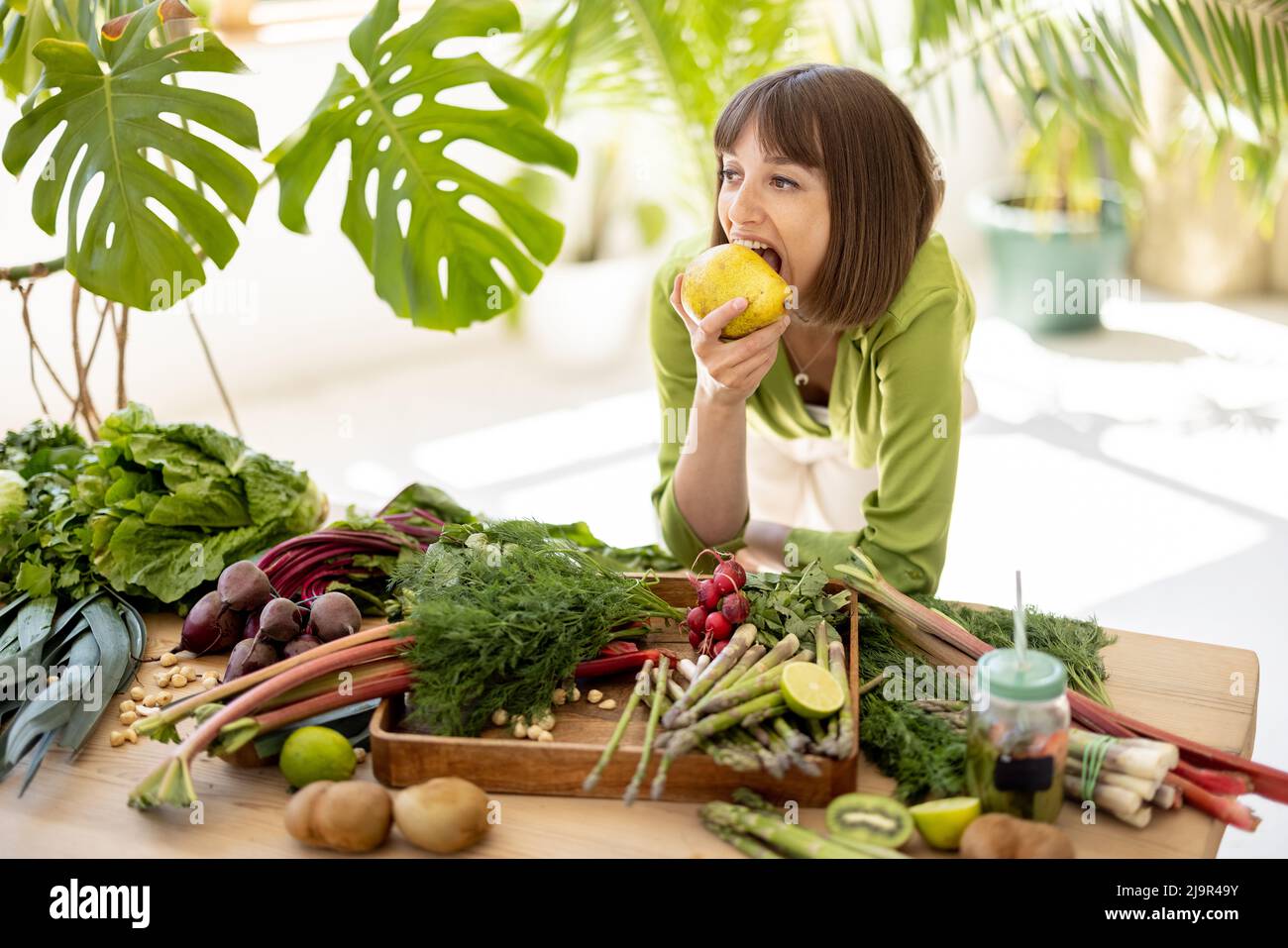 Woman with fresh healthy food ingredients indoors Stock Photo