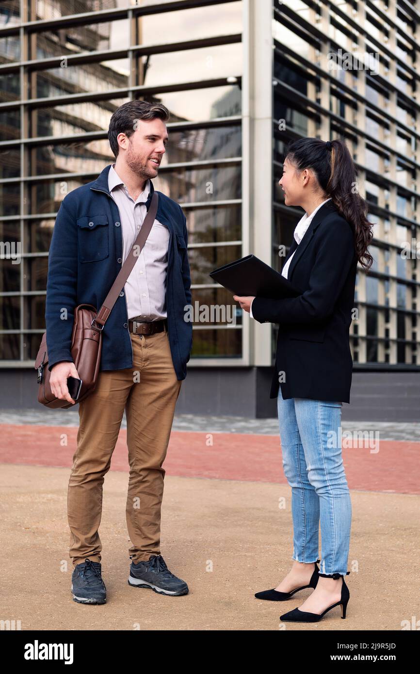 business man and woman in front of office building Stock Photo